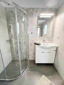 a bathroom with a shower and a sink at Linardo's Cycladic House in Naousa +51 photos