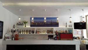 a bar with a counter with bottles of wine at Hotel Fornaro in Caorle