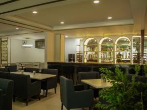 a restaurant with tables and chairs and a bar at El Dorado in Los Mochis