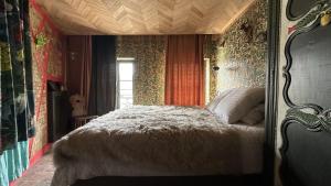a bedroom with a large bed in a room at AU LIT ON DORT - Logis de Village in Bellême