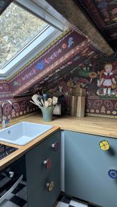 a kitchen with a counter and a sink in a room at AU LIT ON DORT - Logis de Village in Bellême +48 photos