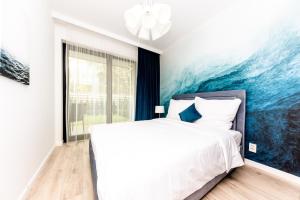 Ένα ή περισσότερα κρεβάτια σε δωμάτιο στο REZYDENCJA NIECHORZE Apart 123 ogrodzony ogródek przy plaży