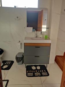 a bathroom with a sink and a mirror at Urubici Maravilhas da Serra 1 in Urubici +2 photos