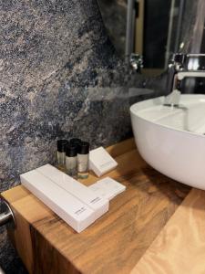 a bathroom with a white sink and a counter with a sink at Class rooms Tirana in Tirana