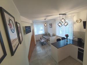 a room with a kitchen and a living room at Apartament Gotowizna in Wadowice