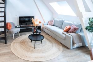 a living room with a couch and a table at 6-bed Aircon House Diaz 60m2, Many Bedrooms in Tilburg