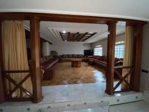 a large living room with couches and a tv at Villa cedra centre ville ifrane zéro six soixante-neuf soixante-huit 3828 in Ifrane