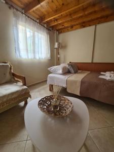 a room with a bed and a table and a couch at ANATOLIS loft houses 2 in Mola Kalyva +8 photos