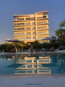 a large building with a pool in front of a hotel at Apartamento Vista al Mar Morros Eco in Cartagena de Indias
