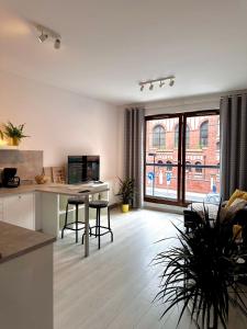 a kitchen and living room with a large window at Apartment A85 City Centre, free parking in Warsaw