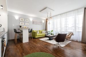 a living room with a couch and a table at City Center Wellness Suites - POOL-GYM-PARKING in Budapest