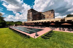 a large building with a swimming pool in front of a building at Mix Brussels --Gym & Wellness for adults only-- in Brussels