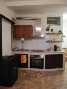 a kitchen with a sink and a stove top oven at La casina in Caprarola