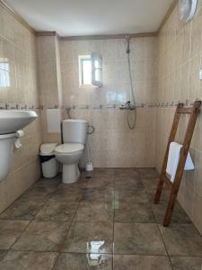 a bathroom with a toilet and a sink and a shower at obzor, orkinos in Obzor