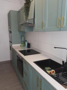 a kitchen with blue cabinets and a sink at Casa Feliz - Stylish 2 Bedroom Apartment in Addis Ababa