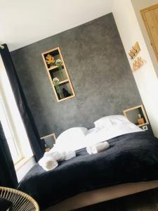 a bedroom with a bed with two mirrors on the wall at Studio Woody entre Disney et Paris in Lagny