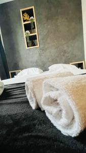 a bedroom with two beds with white towels on them at Studio Woody entre Disney et Paris in Lagny