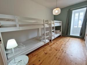 a room with two bunk beds and a lamp at Le Télécab', T5, wifi, cave, ascenseur, 8 personnes in Luchon