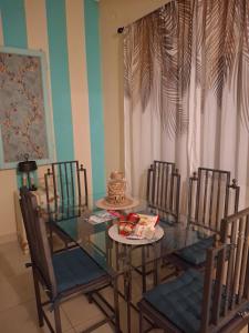 a dining room with a glass table and chairs at Eretria houses in Eretria