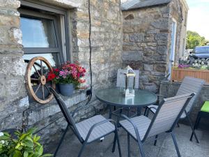 a table and chairs sitting on a patio at Pemberton cottage in Ingleton