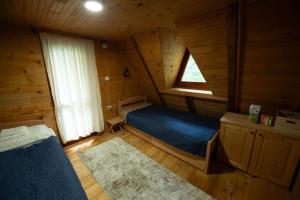 a room with a bed and a window in a cabin at Vikendica Breza in Zaovine +18 photos