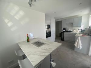 a kitchen with a marble counter top in a room at Beach way in Prestatyn