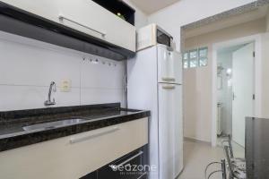 a kitchen with a sink and a refrigerator at Aptos a 2min da praia Balneário Camboriú/SC - EAC in Balneário Camboriú +84 photos