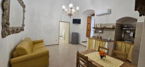 a living room with a couch and a table at Il vicoletto in Canosa di Puglia