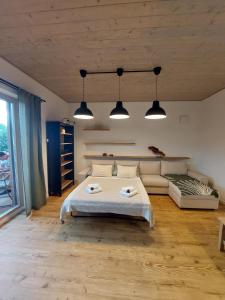 a bedroom with a bed and a couch at Apartmán H3 Hrabušice in Hrabušice