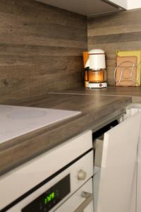 a kitchen with a counter top with a coffee maker at Apartman Goga in Peroj