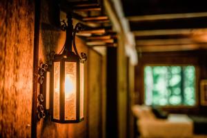 a light hanging on a wall in a room at Northern Nights Chalet by Wanderlust Abodes in Bellaire