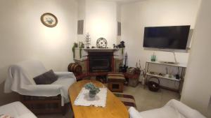a living room with a table and a fireplace at Aura house in Dolna Banya