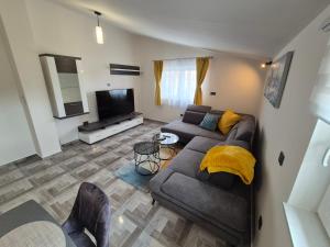 a living room with a couch and a television at Apartment Donata in Privlaka