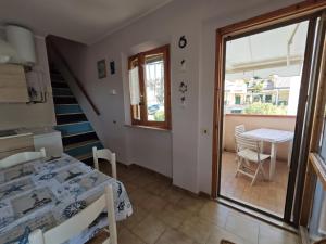 a room with a table and a staircase and a dining room at L06 - Trilocale a 300 mt dal mare in Ancona
