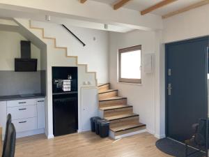a staircase in a room with a kitchen and a kitchen at Pogodny Zakątek in Mosty