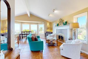a living room with blue chairs and a fireplace at Firepit Lagoon in Oceanside