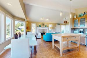 a kitchen with a table and a dining room at Firepit Lagoon in Oceanside