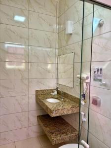 a bathroom with a sink and a mirror at Pousada o Amanhecer in Tiradentes