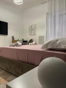a bedroom with a large bed with pink sheets at Labanca's Comfort in Matera
