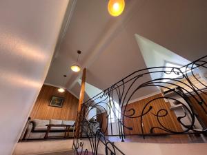 a spiral staircase in a living room with a couch at Green Garden Hotel in Makhinjauri