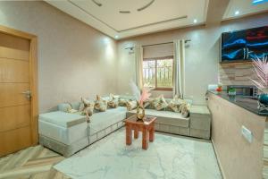a living room with a couch and a window at Blumen Villa in Marrakesh