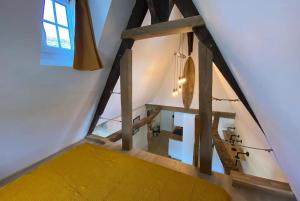 an attic view of a room with a yellow mattress at Morlaix Hyper Centre Charme in Morlaix
