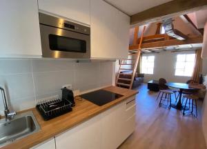 a kitchen with a sink and a stove top oven at Morlaix Hyper Centre Charme in Morlaix