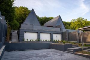 a building with three pointed roofs with a courtyard at Villa Bella Vue in Gabala