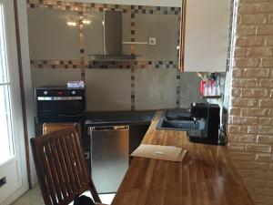 a kitchen with a counter and a sink and a stove at SUN SETE Loft in Sète