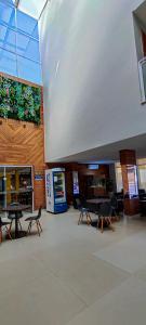 a room with tables and chairs in a building at Sudoeste Hotel in Goiânia