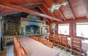 a dining room with a table and a fireplace at Awesome Home In Novo Zvecevo With Sauna in Novo Zvecevo