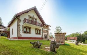 a house with a green lawn in front of it at Awesome Home In Novo Zvecevo With Sauna in Novo Zvecevo +28 photos