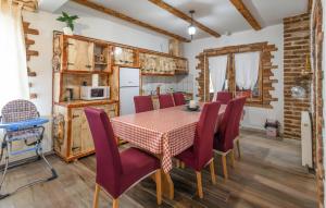 a kitchen and dining room with a table and chairs at Awesome Home In Novo Zvecevo With Sauna in Novo Zvecevo
