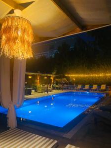 a large swimming pool with a chandelier at Royal Loft Suit in Antalya +111 photos